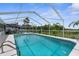 Inviting backyard pool with screened enclosure and lush landscaping for privacy at 2585 Waterfall Dr, Spring Hill, FL 34608