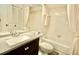 Bathroom with dark vanity, granite countertop, soaking tub and white tile at 2836 Featherstone # 2836, Holiday, FL 34691