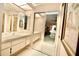 Functional bathroom with vanity and mirrored closet doors at 2836 Featherstone # 2836, Holiday, FL 34691