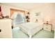 Bedroom with a white comforter on a queen bed and decorative dolls on shelves at 2836 Featherstone # 2836, Holiday, FL 34691