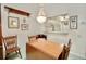 Charming dining area with chandelier and a view to the kitchen, perfect for Gathering meals at 2836 Featherstone # 2836, Holiday, FL 34691