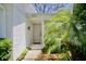 Inviting front entrance with a neutral-colored door, well-maintained garden, and clearly visible address at 2836 Featherstone # 2836, Holiday, FL 34691