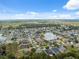 An aerial view shows the community homes surrounding the scenic lake at 3243 Stonegate Falls Dr, Land O Lakes, FL 34638