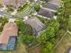 An aerial view shows the backyard firepit area and screened-in patio at 3243 Stonegate Falls Dr, Land O Lakes, FL 34638