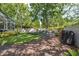 Enjoy the spacious backyard with a hammock and fire pit seating area surrounded by lush greenery at 3243 Stonegate Falls Dr, Land O Lakes, FL 34638