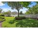 Large backyard with well-maintained lawn and manicured landscaping provides a serene outdoor setting at 3243 Stonegate Falls Dr, Land O Lakes, FL 34638