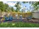Cozy backyard with a fire pit, seating, and string lights, perfect for outdoor gatherings at 3243 Stonegate Falls Dr, Land O Lakes, FL 34638