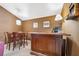 Inviting bar area showcases wooden accents, a table with chairs and ambient lighting for enjoyable entertaining experiences at 3243 Stonegate Falls Dr, Land O Lakes, FL 34638