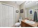 Cozy bathroom featuring a single sink vanity and toilet with framed art on the neutrally painted walls at 3243 Stonegate Falls Dr, Land O Lakes, FL 34638