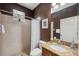 Full bathroom featuring a shower tub combo, granite countertops, and mocha colored walls at 3243 Stonegate Falls Dr, Land O Lakes, FL 34638