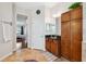 Bathroom featuring wood cabinets, mirror, and view into the bedroom at 3243 Stonegate Falls Dr, Land O Lakes, FL 34638