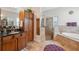 Bathroom featuring double sinks, a soaking tub, and glass shower at 3243 Stonegate Falls Dr, Land O Lakes, FL 34638