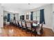 Well-lit dining room featuring hardwood floors, stylish chairs, and blue curtains at 3243 Stonegate Falls Dr, Land O Lakes, FL 34638