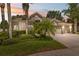 Charming single-story home with lush landscaping, a well-manicured lawn, and a three-car garage at 3243 Stonegate Falls Dr, Land O Lakes, FL 34638