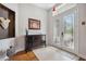 Welcoming foyer featuring tile flooring, a decorative cabinet, and a front door with glass panels at 3243 Stonegate Falls Dr, Land O Lakes, FL 34638