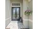Elegant front entrance featuring double doors, decorative window, and a welcoming 'Bienvenue' doormat at 3243 Stonegate Falls Dr, Land O Lakes, FL 34638