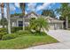 Charming single-story home featuring a well-manicured lawn and tropical landscaping at 3243 Stonegate Falls Dr, Land O Lakes, FL 34638