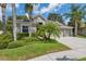 Charming single-story home featuring a well-manicured lawn and tropical landscaping at 3243 Stonegate Falls Dr, Land O Lakes, FL 34638