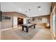Large game room with billiard table, barrel decor, and neutral colored carpet at 3243 Stonegate Falls Dr, Land O Lakes, FL 34638