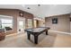 The game room features a pool table and doors leading out to a balcony at 3243 Stonegate Falls Dr, Land O Lakes, FL 34638