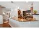 Kitchen featuring granite counters, a breakfast bar, and modern lighting at 3243 Stonegate Falls Dr, Land O Lakes, FL 34638