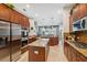Modern kitchen featuring stainless steel appliances, wooden cabinets and granite counters at 3243 Stonegate Falls Dr, Land O Lakes, FL 34638