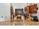 Open kitchen featuring granite counters, wooden cabinets, and stainless appliances at 3243 Stonegate Falls Dr, Land O Lakes, FL 34638