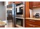Kitchen with stainless steel oven, granite counters and wood cabinets at 3243 Stonegate Falls Dr, Land O Lakes, FL 34638