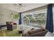 Relaxing lanai featuring comfortable seating and views of trees, creating a perfect spot to unwind and entertain at 3243 Stonegate Falls Dr, Land O Lakes, FL 34638