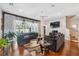 Spacious living room with hardwood floors, comfortable seating, a ceiling fan, and large windows at 3243 Stonegate Falls Dr, Land O Lakes, FL 34638