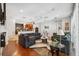 Bright living room featuring hardwood floors, plush seating, and natural light at 3243 Stonegate Falls Dr, Land O Lakes, FL 34638