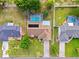 Aerial shot of home with lush landscaping, screened pool, and solar panels at 3468 El Prado Ave, Spring Hill, FL 34609