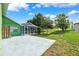 Lush backyard with mature landscaping, a patio, and an enclosed pool area at 3468 El Prado Ave, Spring Hill, FL 34609