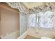 Bathroom featuring a glass enclosed shower with tile surround and floral window coverings at 3468 El Prado Ave, Spring Hill, FL 34609