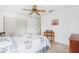 This neutral-toned bedroom includes a ceiling fan and closet at 3468 El Prado Ave, Spring Hill, FL 34609