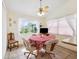 Sunny breakfast nook with large window, ceiling fan and seating for four at 3468 El Prado Ave, Spring Hill, FL 34609