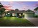 Charming single-story home with lush lawn, mature trees, and attached two-car garage at 3468 El Prado Ave, Spring Hill, FL 34609