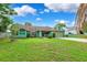 Single-story home featuring lush lawn, a concrete driveway, and an attached two-car garage at 3468 El Prado Ave, Spring Hill, FL 34609