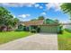 Single-story home featuring lush lawn, a concrete driveway, and an attached two-car garage at 3468 El Prado Ave, Spring Hill, FL 34609
