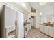A kitchen with neutral cabinets, tan countertops and vaulted ceilings provides a lovely place to cook and gather at 3468 El Prado Ave, Spring Hill, FL 34609