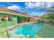 Private pool with an enclosure perfect for relaxing with an adjacent patio area at 3468 El Prado Ave, Spring Hill, FL 34609
