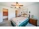 Cozy bedroom with a quilt bedspread, ceiling fan, and access to a cedar closet at 3838 Lanyard Ct # 3838, New Port Richey, FL 34652