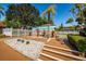 Well-kept community area featuring a building with a mural, landscaping, and palm trees under a blue sky at 3838 Lanyard Ct # 3838, New Port Richey, FL 34652