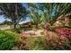 Serene courtyard with a tiered fountain, lush landscaping, and seating areas, offering a peaceful outdoor retreat at 3838 Lanyard Ct # B, New Port Richey, FL 34652