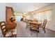 Comfortable dining area with chandelier lighting, wooden chairs, and carpet, adjacent to the living room at 3838 Lanyard Ct # 3838, New Port Richey, FL 34652