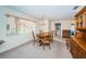 Well-lit dining room with a round wooden table and chairs, featuring a window view and classic chandelier at 3838 Lanyard Ct # 3838, New Port Richey, FL 34652