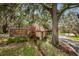 Community entrance with sign for Beacon Lakes Private Way, lush landscaping, and mature trees at 3838 Lanyard Ct # 3838, New Port Richey, FL 34652