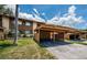 Townhouse with carport, showcasing the exterior with covered parking and well-maintained lawn at 3838 Lanyard Ct # 3838, New Port Richey, FL 34652