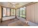 Enclosed Florida room with window coverings and backyard views at 3838 Lanyard Ct # B, New Port Richey, FL 34652