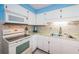 Bright kitchen with white cabinetry, modern appliances, and a tiled backsplash for a fresh look at 3838 Lanyard Ct # B, New Port Richey, FL 34652